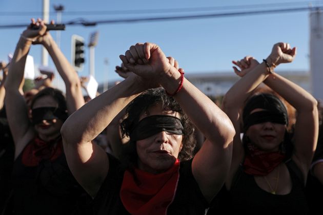 Women rights activists and people wearing blindfolds participate in a protest opposing violence against women and against Chile's government in Santiago, Chile December 4, 2019. REUTERS/Pablo Sanhueza