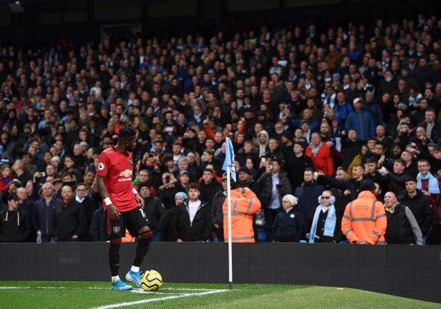 MANCHESTER, ENGLAND - DECEMBER 07: Fred of Manchester United looks to the crowd as missiles are thrown form the stands during the Premier League match between Manchester City and Manchester United at Etihad Stadium on December 07, 2019 in Manchester, United Kingdom. (Photo by Laurence Griffiths/Getty Images)