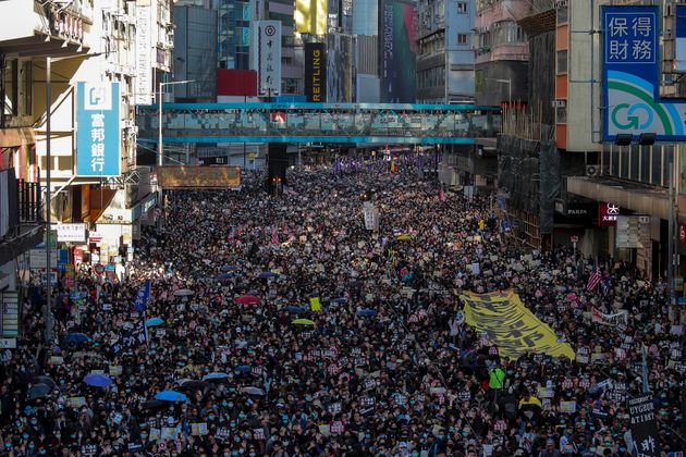 Pro-democracy protesters march on a street during a protest in Hong Kong, Sunday, Dec. 8, 2019. Thousands of people took to the streets of Hong Kong on Sunday in a march seen as a test of the enduring appeal of an anti-government movement about to mark a half year of demonstrations. (AP Photo/Kin Cheung)