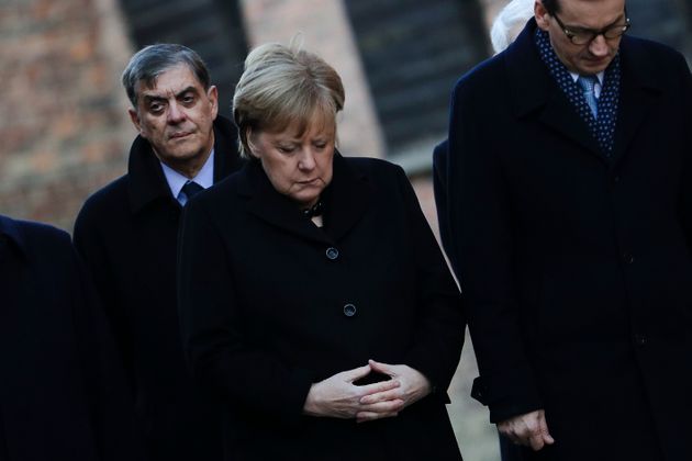 German Chancellor Angela Merkel and Polish Prime Minister Mateusz Morawiecki the commemorate the victims of the former Nazi death camp Auschwitz-Birkenau at the death wall inside the camp in Oswiecim, Germany, Friday, Dec. 6, 2019. Merkel visit the former death camp in occasion of the 10th anniversary of the founding of the Auschwitz Foundation. (Photo/Markus Schreiber)