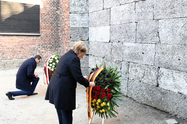 Polish Prime Minister Mateusz Morawiecki and German Chancellor Angela Merkel attend a wreath-laying ceremony at the Auschwitz-Birkenau memorial in Oswiecim, Poland December 6, 2019. Jakub Porzycki/Agencja Gazeta via REUTERS  ATTENTION EDITORS - THIS IMAGE WAS PROVIDED BY A THIRD PARTY. POLAND OUT. NO COMMERCIAL OR EDITORIAL SALES IN POLAND.