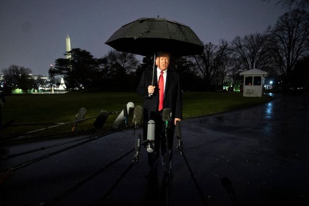 WASHINGTON, DC  DECEMBER 10: U.S. President Donald Trump holds an umbrella as he speaks to journalists before boarding Marine One on the South Lawn of the White House on December 10, 2019 in Washington, DC. Trump is headed to Hershey, Pennsylvania for a campaign rally. Earlier in the day, House Democrats announced they will seek two articles of impeachment against the president. (Photo by Drew Angerer/Getty Images)