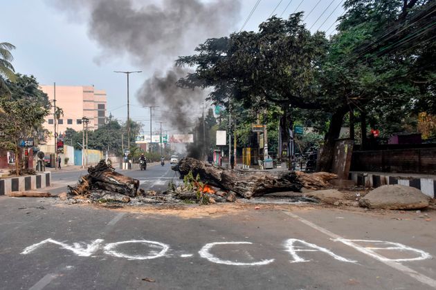 TOPSHOT - Trees are burning in the middle of a road during a curfew in Guwahati on December 12, 2019, following protests over the government's Citizenship Amendment Bill (CAB). - Authorities deployed thousands of paramilitaries and blocked mobile internet in northeast India on December 12, while police fired blank rounds at protesters who defied a curfew to demonstrate against contentious new citizenship legislation. (Photo by Biju BORO / AFP) (Photo by BIJU BORO/AFP via Getty Images)