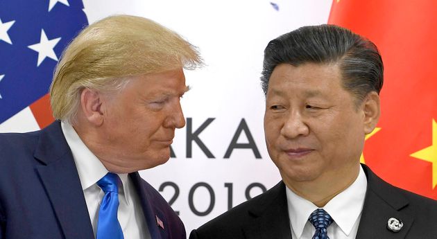 FILE - In this  June 29, 2019, file photo, U.S. President Donald Trump, left, shakes hands with Chinese President Xi Jinping during a meeting on the sidelines of the G-20 summit in Osaka, western Japan. Facing another U.S. tariff hike, Xi is getting tougher with Washington instead of backing down. Both sides have incentives to settle a trade war that is battering exporters on either side of the Pacific and threatening to tip the global economy into recession. (AP Photo/Susan Walsh, File)