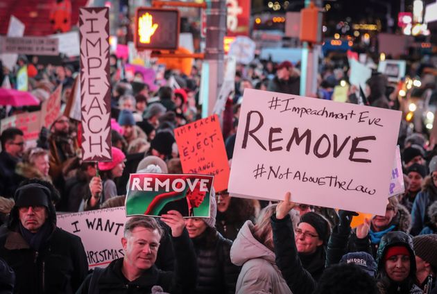 An anti-President Donald Trump crowd gather at a rally to protest and call for his impeachment, Tuesday Dec. 17, 2019, in New York's Times Square. (AP Photo/Bebeto Matthews)