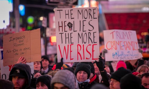 An anti-President Trump crowd gather at a rally to protest and call for his impeachment, Tuesday Dec. 17, 2019, in New York's Times Square. (AP Photo/Bebeto Matthews)