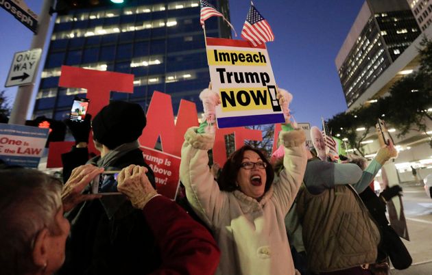 Houstonians gather outside the office of U.S. Sen. Ted Cruz, R-Texas, as part of a national protest in support of impeachment on Tuesday, Dec. 17, 2019 in Houston. (Elizabeth Conley/Houston Chronicle via AP)