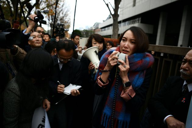 Japanese journalist Shiori Ito speaks to reporters outside the Tokyo district court on December 18, 2019 after hearing the ruling on a damages lawsuit by her, accusing a former TV reporter of rape. - A Tokyo court awarded 3.3 million yen ($30,000) in damages to journalist Shiori Ito, who accused a former TV reporter of rape in a high-profile case that spotlighted the '#metoo' movement in Japan. (Photo by CHARLY TRIBALLEAU / AFP) (Photo by CHARLY TRIBALLEAU/AFP via Getty Images)