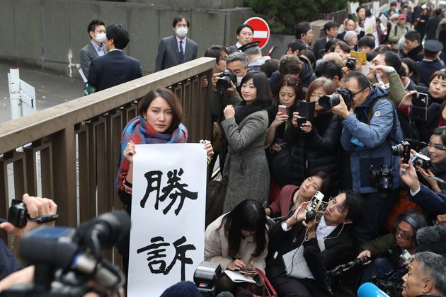 TOKYO, JAPAN - DECEMBER 18: Shiori Ito holds up signs showing victory in front of the Tokyo District Court on December 18, 2019 in Tokyo, Japan. A Tokyo court awarded 3.3 million yen (US$30,000) in damages to journalist Shiori Ito, who accused a former TV reporter of rape in one of Japanese #MeToo movement cases. (Photo by Takashi Aoyama/Getty Images)