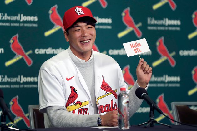 St. Louis Cardinals pitcher Kwang-Hyun Kim smiles as he holds up a sign during a news conference Tuesday, Dec. 17, 2019, in St. Louis. The Cardinals have signed the Korean left-hander to a two-year contract. (AP Photo/Jeff Roberson)