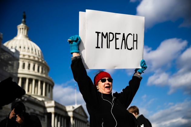 Protesters demonstrate as the House of Representatives debates on the articles of impeachment against President Donald Trump at the U.S. Capitol building, Wednesday, Dec. 18, 2019, on Capitol Hill in Washington. (AP Photo/Matt Rourke)