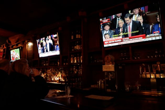 A patron watches a television screen at the Hawk 'n' Dove bar showing Rep. Devin Nunes, R-Calif., as he speaks during an impeachment hearing at the U.S. Capitol, Wednesday, Dec. 18, 2019, on Capitol Hill in Washington. President Donald Trump is on the cusp of being impeached by the House, with a historic debate set Wednesday on charges that he abused his power and obstructed Congress ahead of votes that will leave a defining mark on his tenure at the White House. (AP Photo/Julio Cortez)