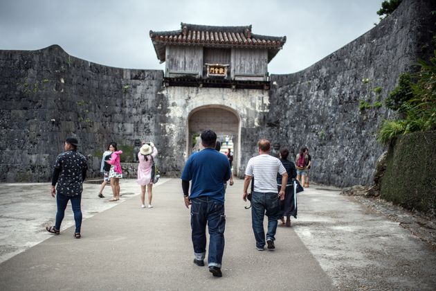 NAHA, JAPAN - JUNE 01: Tourists visit Shuri Castle on June 1, 2018 in Naha, Japan. Like the rest of Japan, the southern island of Okinawa has seen a recent surge in tourist numbers with the island now hosting more foreign visitors annually than Hawaii. (Photo by Carl Court/Getty Images)