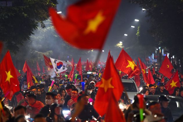 December 10, 2019 shows Vietnamese fans celebrating on the streets in Hanoi following Vietnam's victory over Indonesia in the men's football final match at the SEA Games (Southeast Asian Games).