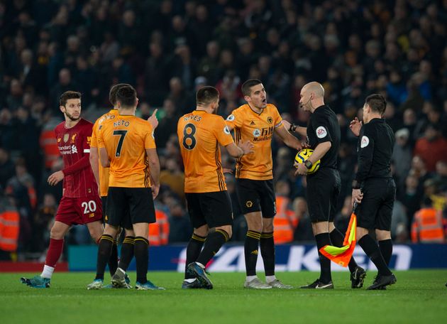 LIVERPOOL, ENGLAND - DECEMBER 29: Wolverhampton Wanderers players complain to referee Anthony Taylor at half time folllowing a controversial VAR decision during the Premier League match between Liverpool FC and Wolverhampton Wanderers at Anfield on December 29, 2019 in Liverpool, United Kingdom. (Photo by Visionhaus)