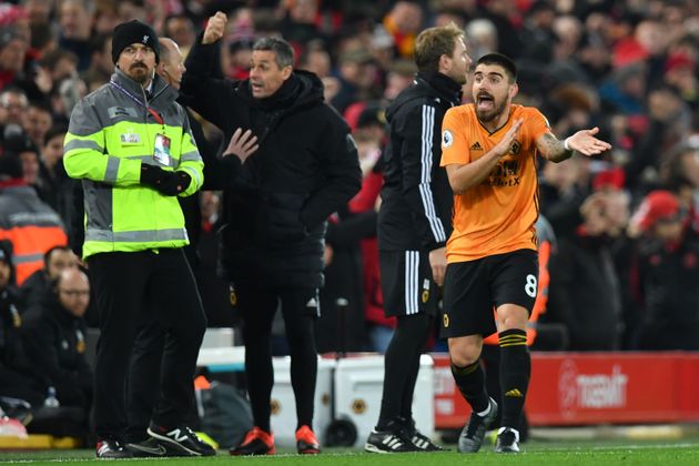 Wolverhampton Wanderers' Portuguese midfielder Ruben Neves gestures after VAR confirms the opening goal for Liverpool during the English Premier League football match between Liverpool and Wolverhampton Wanderers at Anfield in Liverpool, north west England, on December 29, 2019. (Photo by Paul ELLIS / AFP) / RESTRICTED TO EDITORIAL USE. No use with unauthorized audio, video, data, fixture lists, club/league logos or 'live' services. Online in-match use limited to 120 images. An additional 40 images may be used in extra time. No video emulation. Social media in-match use limited to 120 images. An additional 40 images may be used in extra time. No use in betting publications, games or single club/league/player publications. /  (Photo by PAUL ELLIS/AFP via Getty Images)