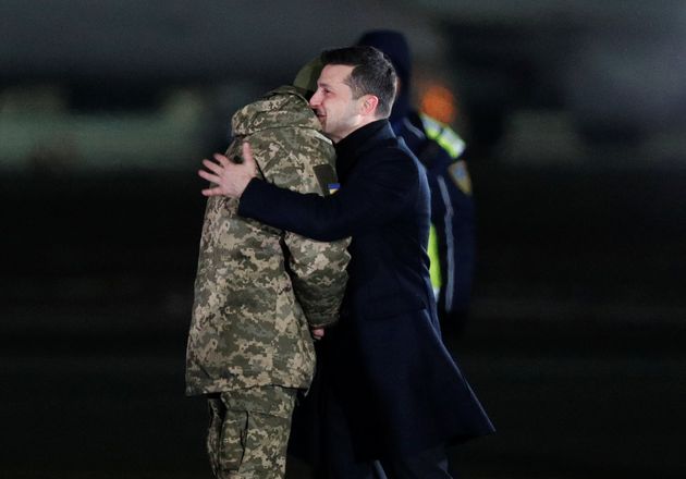 Ukraine's President Volodymyr Zelenskiy greets a Ukrainian serviceman during a ceremony to welcome citizens, who were exchanged in a prisoners of war (POWs) swap with the separatist self-proclaimed republics, at the Boryspil International Airport outside Kiev, Ukraine December 29, 2019. REUTERS/Valentyn Ogirenko