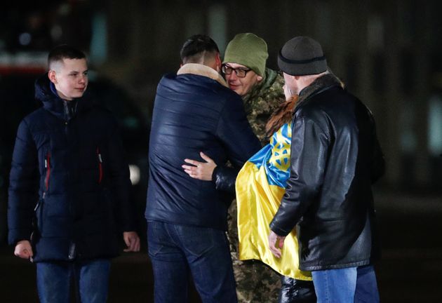 Relatives and acquaintances embrace a Ukrainian serviceman, who was exchanged during a prisoners of war (POWs) swap between Ukraine and the separatist self-proclaimed republics, during a welcoming ceremony at the Boryspil International Airport outside Kiev, Ukraine December 29, 2019. REUTERS/Valentyn Ogirenko