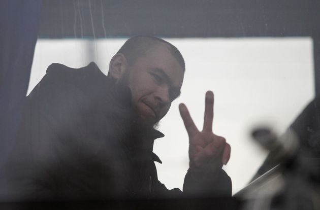 A prisoner of war gestures a victory sign inside a bus upon the arrival after he was released by Ukrainian authorities and exchanged during a captives' swap between Ukraine and the separatist republics near the Mayorsk crossing point in Donetsk region, Ukraine December 29, 2019. REUTERS/Alexander Ermochenko