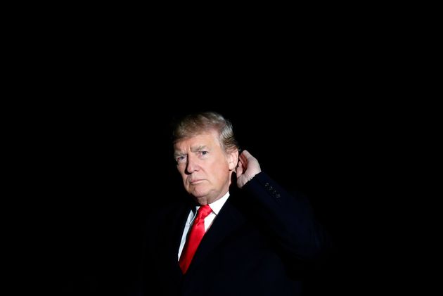 President Donald Trump places his hand to his ear to hear a reporter's question as he walks on the South Lawn of the White House after stepping off Marine One, Monday, Dec. 4, 2017, in Washington, as he returns from a trip to Utah. (AP Photo/Alex Brandon)