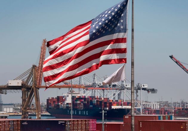 The US flag flies over a container ship unloading it's cargo from Asia, at the Port of Long Beach, California on August 1, 2019. - President Donald Trump announced August 1 that he will hit China with punitive tariffs on another $300 billion in goods, escalating the trade war after accusing Beijing of reneging on more promises. (Photo by Mark RALSTON / AFP) (Photo by MARK RALSTON/AFP via Getty Images)