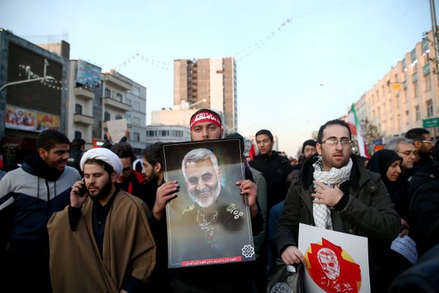 An Iranian man holds a picture of Qassem Soleimani during a funeral procession for Iranian Major-General Qassem Soleimani, head of the elite Quds Force, and Iraqi militia commander Abu Mahdi al-Muhandis, who were killed in an air strike at Baghdad airport, in Tehran, Iran January 6, 2020. Nazanin Tabatabaee/WANA (West Asia News Agency) via REUTERS ATTENTION EDITORS - THIS IMAGE HAS BEEN SUPPLIED BY A THIRD PARTY