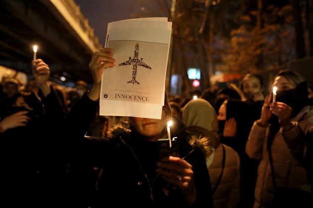 People gather for a candlelight vigil to remember the victims of the Ukraine plane crash, at the gate of Amri Kabir University that some of the victims of the crash were former students of, in Tehran, Iran, Saturday, Jan. 11, 2020. Iran on Saturday, Jan. 11, acknowledged that its armed forces 'unintentionally' shot down the Ukrainian jetliner that crashed earlier this week, killing all 176 aboard, after the government had repeatedly denied Western accusations that it was responsible. (AP Photo/Ebrahim Noroozi)