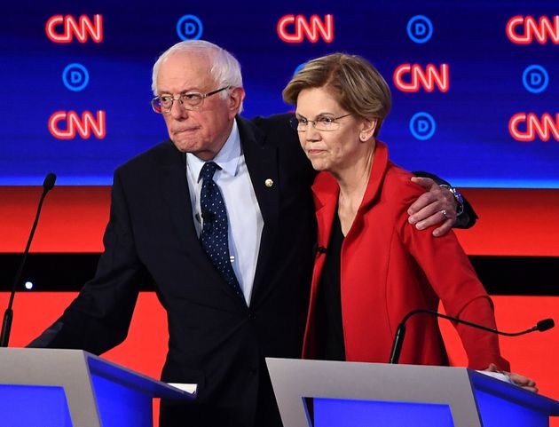 (FILES) In this file photo taken on July 30, 2019 Democratic presidential hopefuls US Senator from Vermont Bernie Sanders (L) and US Senator from Massachusetts Elizabeth Warren hug after participating in the first round of the second Democratic primary debate of the 2020 presidential campaign season in Detroit, Michigan. (Photo by Brendan Smialowski / AFP) (Photo credit should read BRENDAN SMIALOWSKI/AFP via Getty Images)