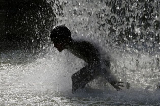 A child cools off in the Trocadero fountains in Paris
