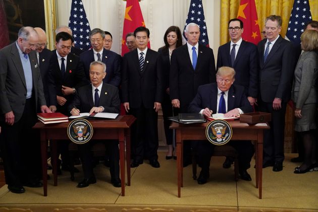 Chinese Vice Premier Liu He and U.S. President Donald Trump sign 'phase one' of the U.S.-China trade agreement during a ceremony in the East Room of the White House in Washington, U.S., January 15, 2020. REUTERS/Kevin Lamarque