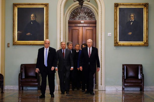 Supreme Court Chief Justice John Roberts is escorted by Sen. Lindsey Graham, R-S.C., center left, Sen. Patrick Leahy, D-Vt., right, Sen. Dianne Feinstein, D-Calif., and Sen. Roy Blunt, R-Mo., toward the Senate chamber at the U.S. Capitol in Washington, Thursday, Jan. 16, 2020. (AP Photo/Matt Rourke)