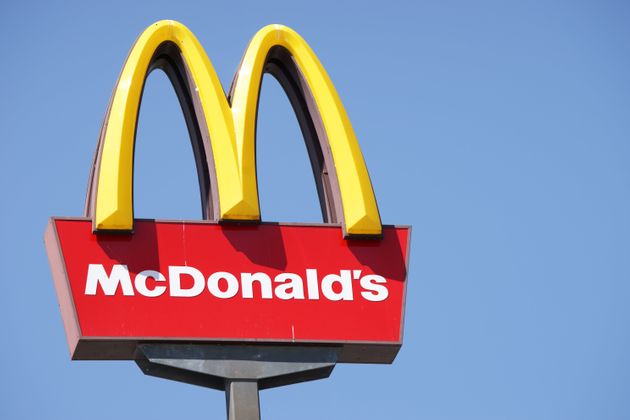 Ljubljana, Slovenia - September 3, 2011: Close-up of McDonalds outdoor sign with  typical rounded yellow M letter against cloudless blue sky. Sign is positioned on the left side of image.