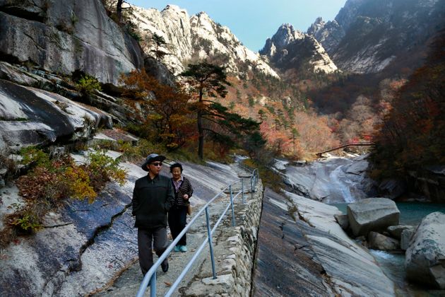 FILE - In this Oct. 23, 2018, file photo, local tourists walk on the trail at Mount Kumgang, known as Diamond Mountain, in North Korea. South Korea said Wednesday, Nov. 6, 2019 it offered to send a delegation to check on facilities at a long-stalled joint tourist resort in North Korea. North Korean leader Kim Jong Un recently ordered the destruction of South Korean-made hotels and other facilities at the North's Diamond Mountain resort, saying they appear 'shabby' and 'unpleasant-looking.' (AP Photo/Dita Alangkara, File)