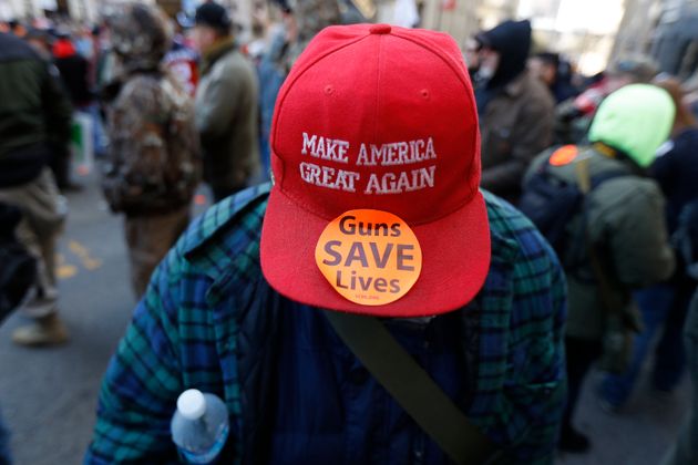 A man walks in the crowd during a pro-gun rally, Monday, Jan. 20, 2020, in Richmond, Va. (AP Photo/Julio Cortez)