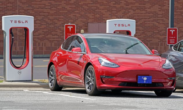 A Tesla vehicle is shown charging at a Tesla Supercharger site in Charlotte, N.C., Friday, July 19, 2019. (AP Photo/Chuck Burton)