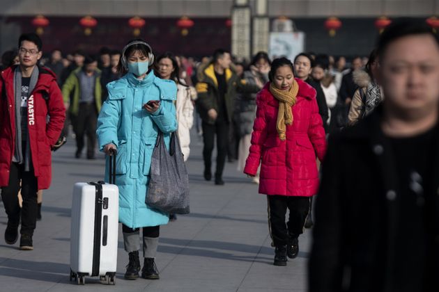Passengers arrive at the train station in Hanzhong, a mountainous region of Shaanxi province on January 20, 2020, ahead of the Lunar New Year. - A mysterious SARS-like virus has killed a third person and spread around China -- including to Beijing -- authorities said on January 20, fuelling fears of a major outbreak as millions begin travelling for the Lunar New Year in humanity's biggest migration. (Photo by NOEL CELIS / AFP) (Photo by NOEL CELIS/AFP via Getty Images)