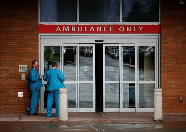 Employees in scrubs talk next to the ambulance entrance at Providence Regional Medical Center after a spokesman from the U.S. Centers for Disease Control and Prevention (CDC) said a traveler from China has been the first person in the United States to be diagnosed with the Wuhan coronavirus, in Everett, Washington, U.S. January 21, 2020.  REUTERS/Lindsey Wasson