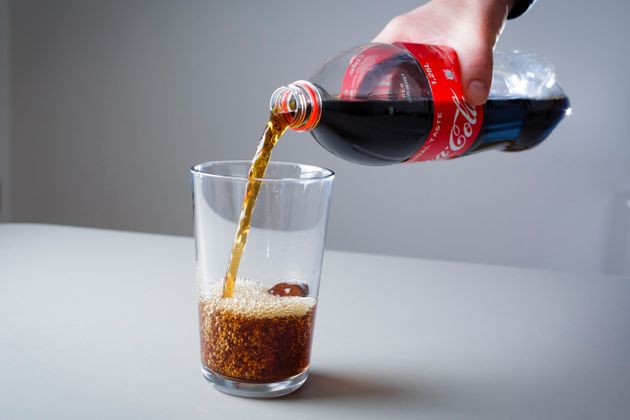 Berlin, Germany - April 16: Coca Cola is poured from a bottle into a glass on April 16, 2019 in Berlin, Germany. (Photo Illustration by Thomas Trutschel/Photothek via Getty Images)