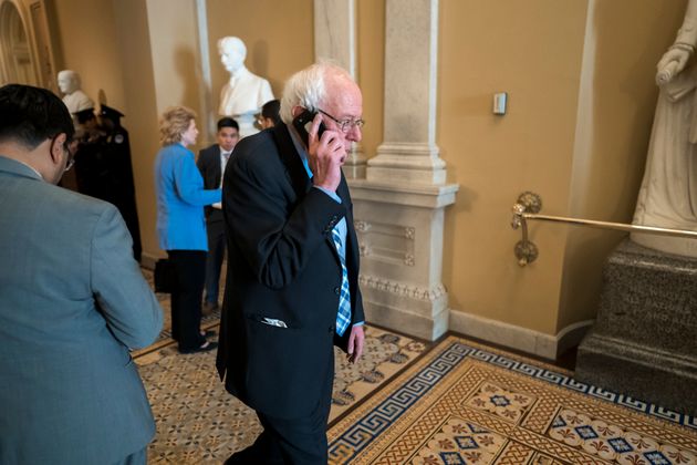 Democratic presidential candidate, Sen. Bernie Sanders, I-Vt., makes a phone call during a break as the Senate continues with the impeachment trial of President Donald Trump on charges of abuse of power and obstruction of Congress, at the Capitol in Washington, Wednesday, Jan. 22, 2020. (AP Photo/J. Scott Applewhite)