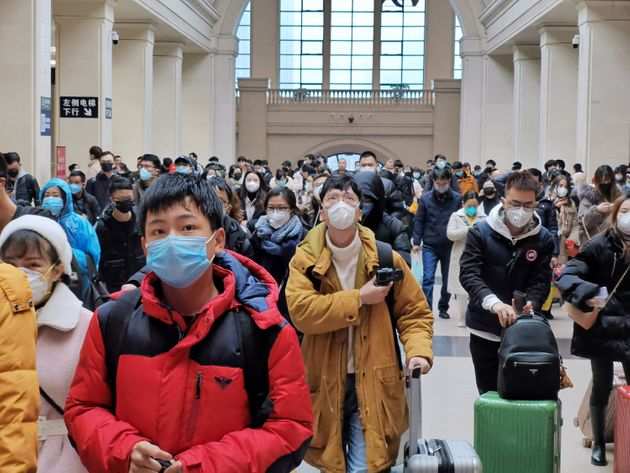 WUHAN, CHINA - JANUARY 22: People wear face masks as they wait at Hankou Railway Station on January 22, 2020 in Wuhan, China. A new infectious coronavirus known as '2019-nCoV' was discovered in Wuhan last week. Health officials stepped up efforts to contain the spread of the pneumonia-like disease which medical experts confirmed can be passed from human to human. Cases have been reported in other countries including the United States,Thailand, Japan, Taiwan, and South Korea. It is reported that Wuhan will suspend all public transportation at 10 AM on January 23, 2020.  (Photo by Xiaolu Chu/Getty Images)