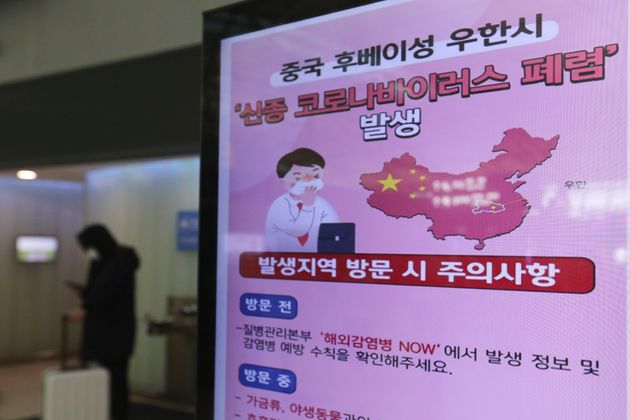 A poster warning about coronavirus is displayed in a departure lobby at Incheon International Airport in Incheon, South Korea, Monday, Jan. 27, 2020. China on Monday expanded sweeping efforts to contain a viral disease by extending the Lunar New Year holiday to keep the public at home and avoid spreading infection. The sign reads ' A new coronavirus occurs in Wuhan City, China.' (AP Photo/Ahn Young-joon)
