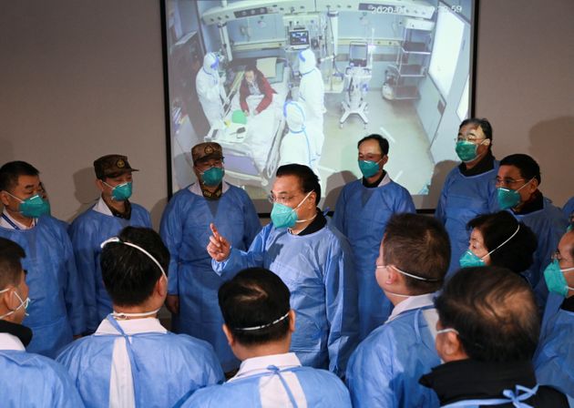 Chinese Premier Li Keqiang wearing a mask and protective suit speaks to medical workers as he visits the Jinyintan hospital where the patients of the new coronavirus are being treated following the outbreak, in Wuhan, Hubei province, China January 27, 2020. cnsphoto via REUTERS. ATTENTION EDITORS - THIS IMAGE WAS PROVIDED BY A THIRD PARTY. CHINA OUT.     TPX IMAGES OF THE DAY