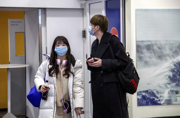 Air travellers wear masks as they arrive at Ivalo Airport, Finland January 24, 2020. On Thursday, two tourists visiting Finland from Wuhan, China went to a health centre in Ivalo, seeking treatment for flu-like symptoms. The tourists are suspected of being infected with the coronavirus. Lehtikuva/Tarmo Lehtosalo via REUTERS ATTENTION EDITORS - THIS IMAGE HAS BEEN PROVIDED BY A THIRD PARTY. FINLAND OUT. NO THIRD PARTY SALES.