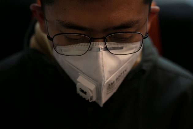 A man wears a mask as he travels on a train Wednesday, Jan. 29, 2020, in the Odaiba district of Tokyo. Japanese officials say four evacuees on a flight from the Chinese city of Wuhan have a cough and fever. Tokyo Metropolitan Government confirmed their condition after the flight of 206 evacuees arrived in Tokyo. (AP Photo/Jae C. Hong)