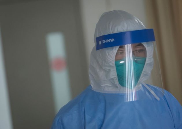 In this photo released by China's Xinhua News Agency, a medical staff member wearing protective a suit works in the department of infectious diseases at Wuhan Union Hospital in Wuhan in central China's Hubei Province, Tuesday, Jan. 28, 2020. Hong Kong's leader announced Tuesday that all rail links to mainland China will be cut starting Friday as fears grow about the spread of a new virus. (Xiao Yijiu/Xinhua via AP)