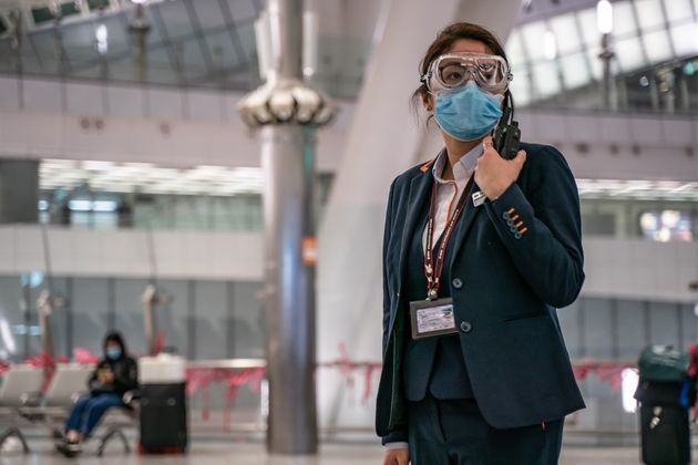 HONG KONG, CHINA - JANUARY 29: A MTR staff wearing protective goggles and mask stands by in the departure hall at Hong Kong High Speed Rail Station on January 29, 2020 in Hong Kong, China. Hong Kong government will deny entry for travellers who has been to Hubei province except for local residents in response to tighten the international travel and border crossing to stop the spread of the virus. (Photo by Anthony Kwan/Getty Images)