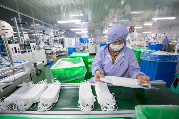 HAI'AN, CHINA - JANUARY 28 2020: A woman worker checks the medical masks at a plant of medical supply in Hai'an city in east China's Jiangsu province Tuesday, Jan. 28, 2020.- PHOTOGRAPH BY Feature China / Barcroft Media (Photo credit should read Feature China/Barcroft Media via Getty Images)