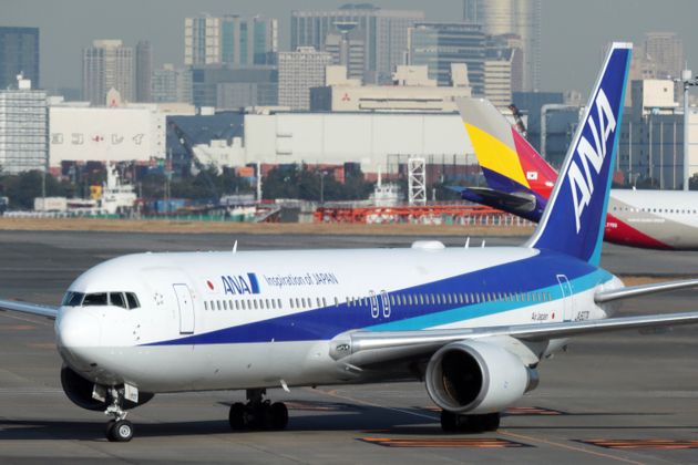 An All Nippon Airways Boeing 767-300 aircraft, operating on its second charter flight from the Chinese city of Wuhan which was arranged by Japan's government to evacuate its citizens, lands at Haneda airport in Tokyo on January 30, 2020. - Three Japanese citizens among more than 200 on a first evacuation flight from China have tested positive for a new strain of coronavirus, Japan's health minister said January 30. (Photo by STR / JIJI PRESS / AFP) / Japan OUT (Photo by STR/JIJI PRESS/AFP via Getty Images)
