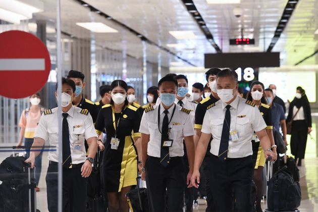 The flight crew of the chartered Scoot airline which flew to Wuhan to evacuate Singaporean nationals arrive at Changi international airport on Singapore on January 30, 2020. (Photo by Roslan RAHMAN / AFP) (Photo by ROSLAN RAHMAN/AFP via Getty Images)