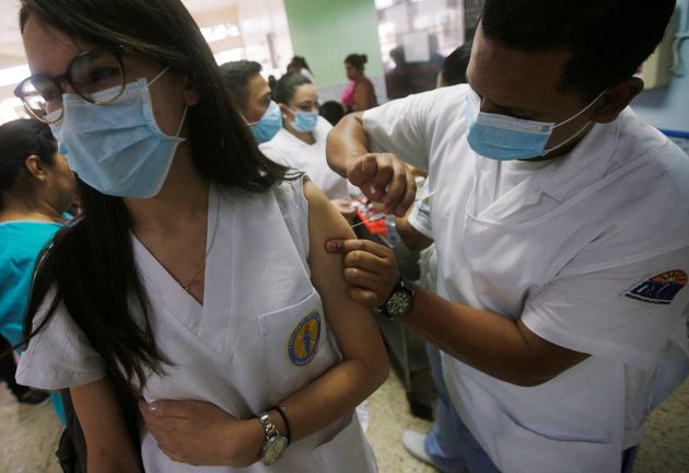 Medical personnel of a hospital receives vaccination for influenza A H1N1, in Tegucigalpa, Honduras May 15, 2018. REUTERS/Jorge Cabrera